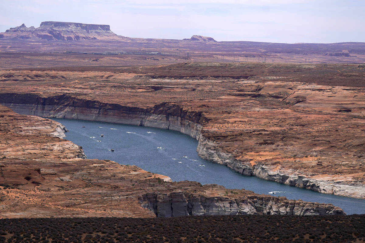 Boats move along Lake Powell along the Upper Colorado River Basin, June 9, 2021, in Wahweap, Ar ...