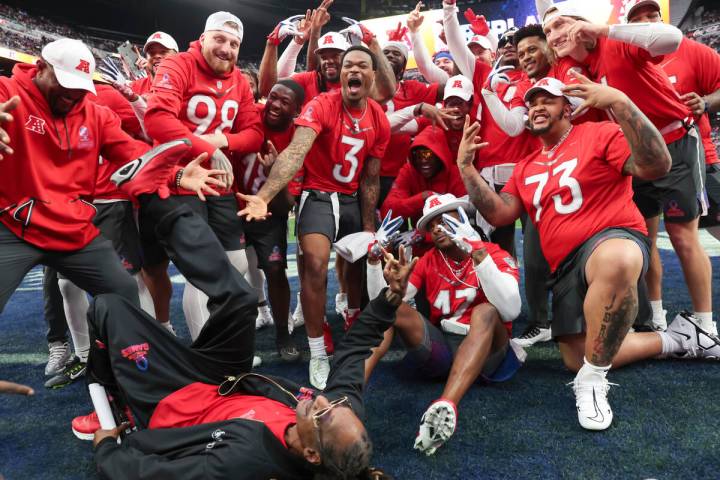Members of the AFC team, including honorary captain Snoop Dogg, lower left, pose for a photo wh ...