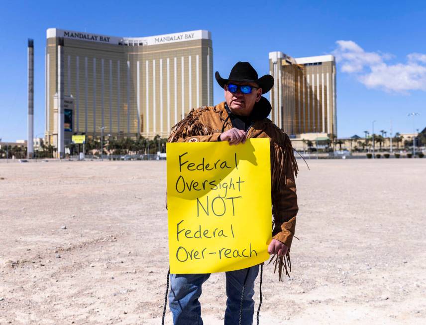 Todd Hall, a member of North Dakota's Mandan, Hidatsa and Arikara Nation (MHA), holds a sign as ...