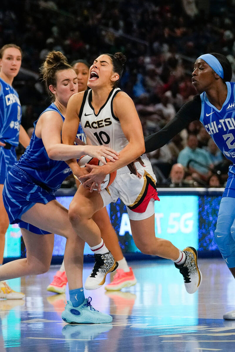 Las Vegas Aces guard Kelsey Plum, center, drives between Chicago Sky guard Marina Mabrey, left, ...