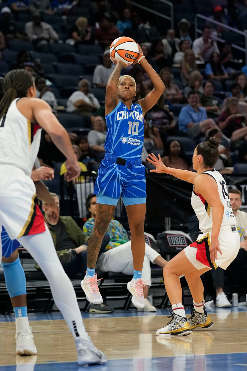 Chicago Sky guard Courtney Williams shoots next to Las Vegas Aces guard Kelsey Plum, right, dur ...