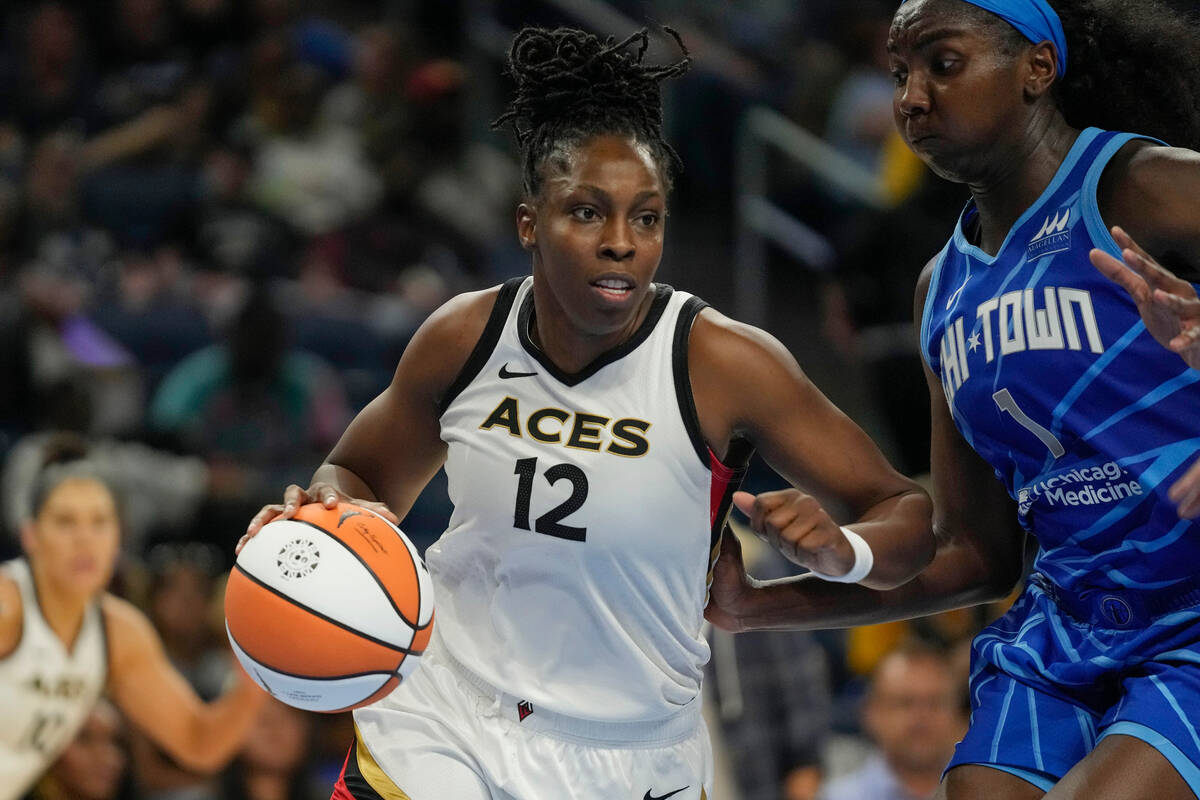 Las Vegas Aces guard Chelsea Gray, left, dribbles the ball around Chicago Sky center Elizabeth ...