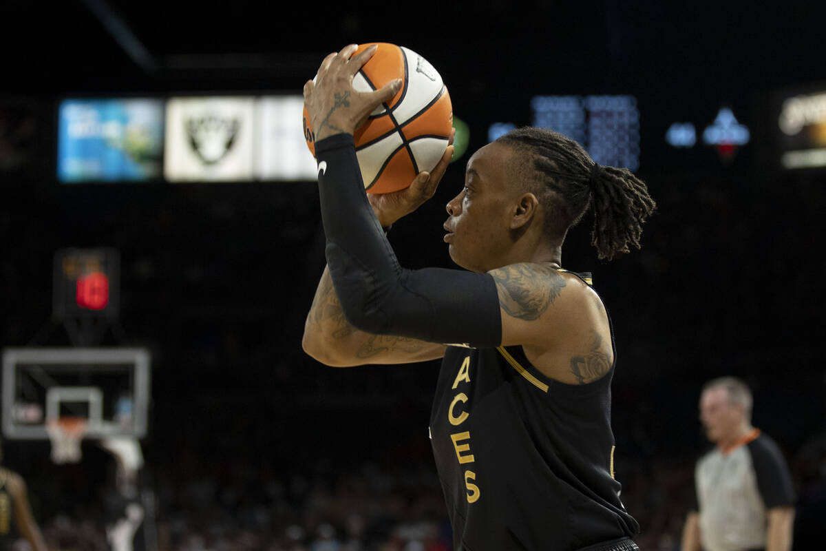 Aces guard Riquna Williams (2) gets a shot off in the first half of the game at Michelob Ultra ...