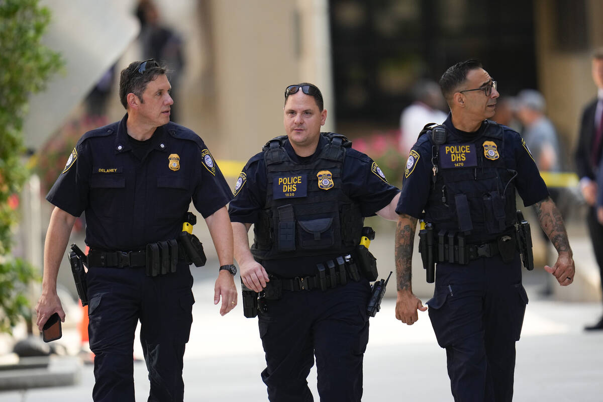 Officials are seen outside the J. Caleb Boggs Federal Building ahead of a court appearance sche ...