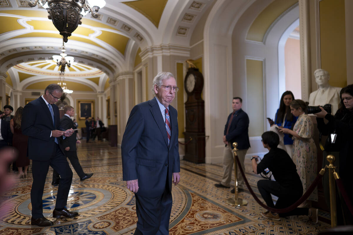 Senate Minority Leader Mitch McConnell, R-Ky., walks to speak with reporters at the Capitol in ...
