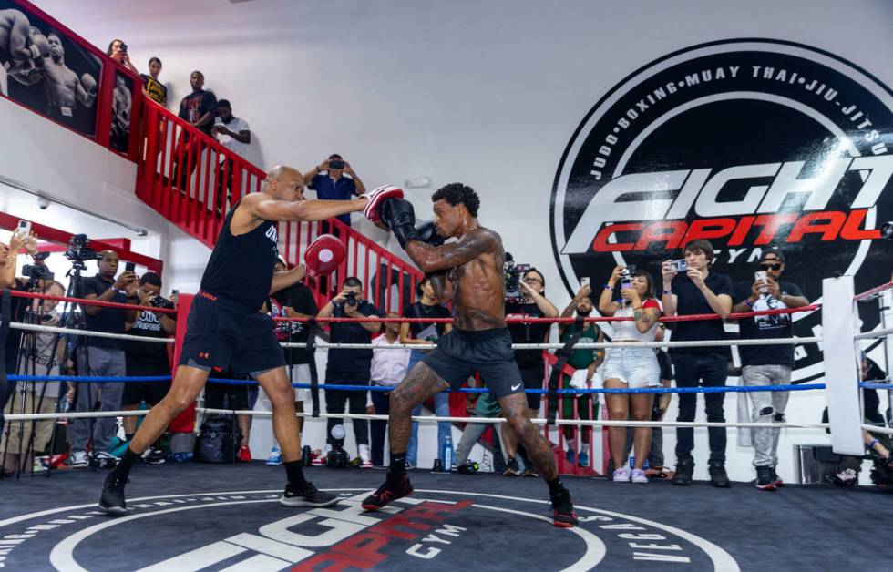 Fighter Errol Spence Jr. hits the pads with trainer Derrick James during a media workout day at ...