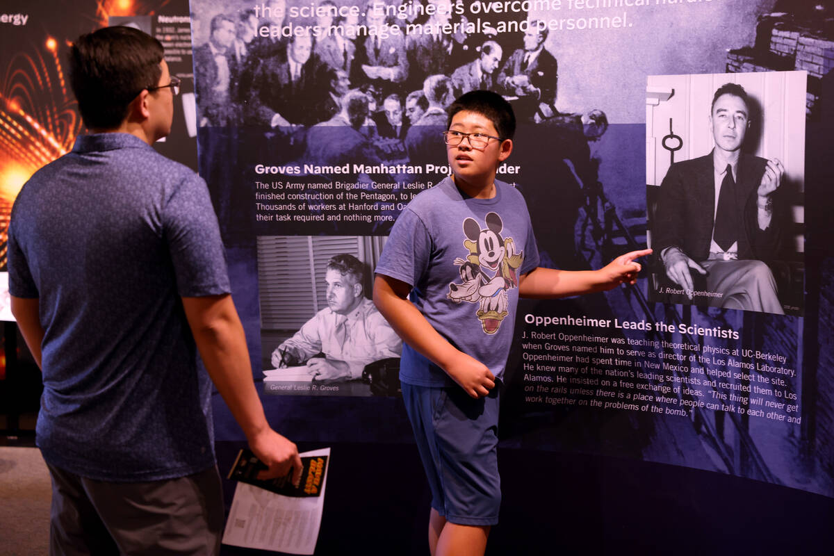 Dennis Heng, 12, and his father Chamroeun Heng check out a display featuring J. Robert Oppenhei ...