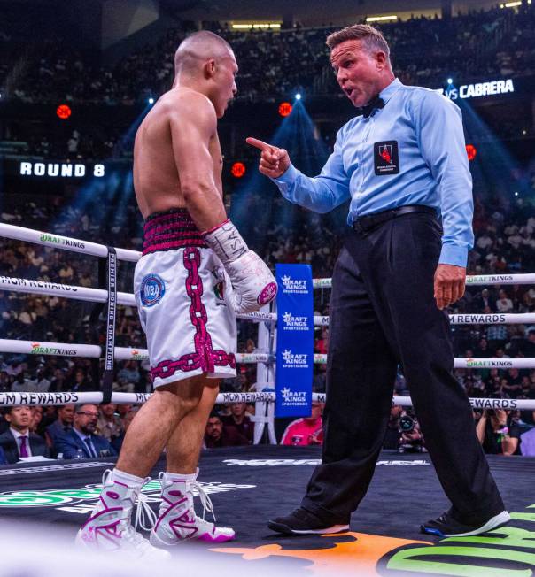 Isaac Cruz is warned about a head butt on Giovanni Cabrera in round 8 during world welterweight ...