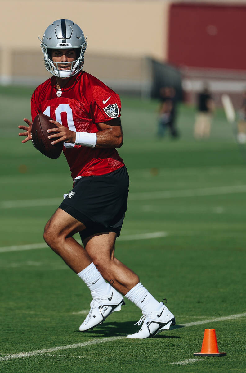 Raiders quarterback Jimmy Garoppolo looks to throw the ball during a drill at training camp at ...