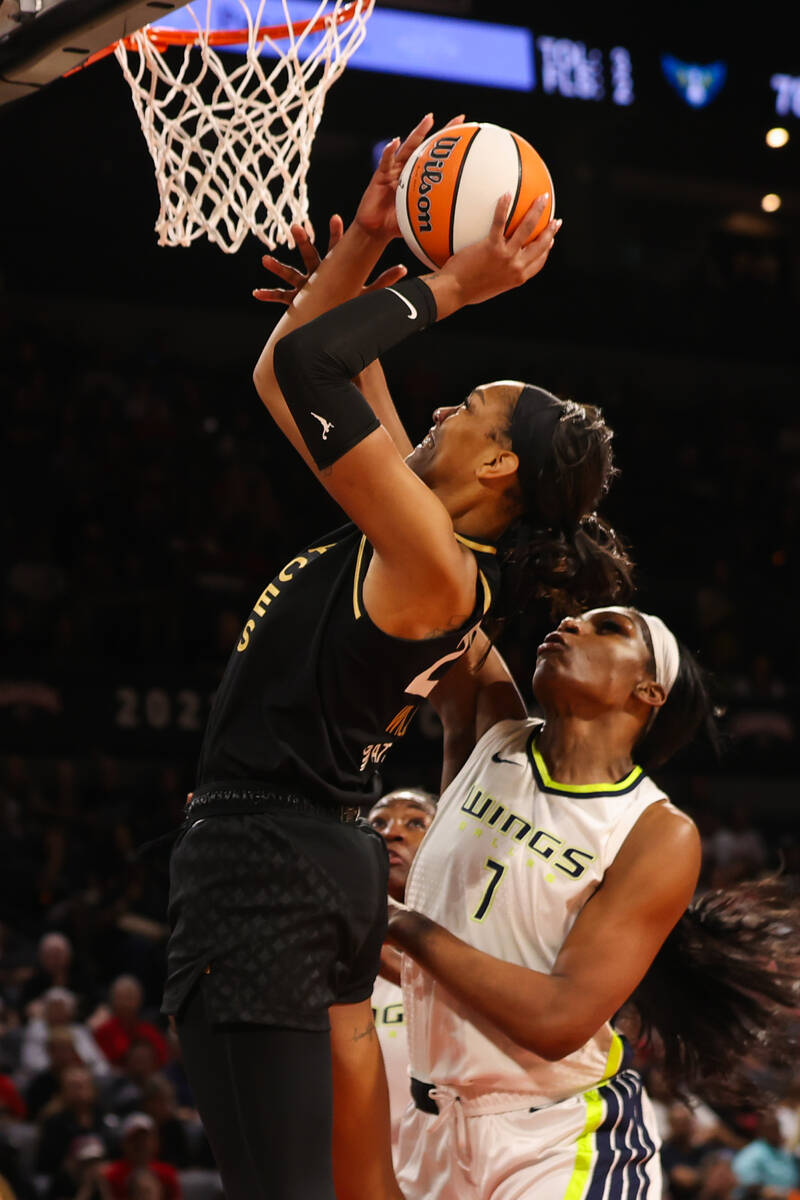 Las Vegas Aces forward A'ja Wilson (22) goes for a layup around Dallas Wings center Teaira McCo ...