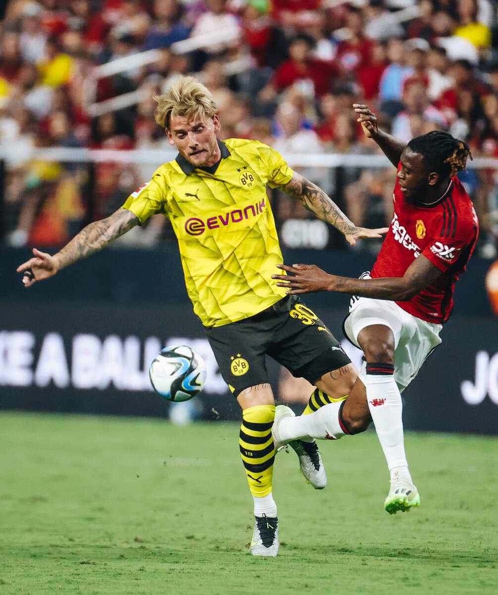 Borussia Dortmund winger Ole Pohlmann (30) fights for then all with Manchester United right-bac ...