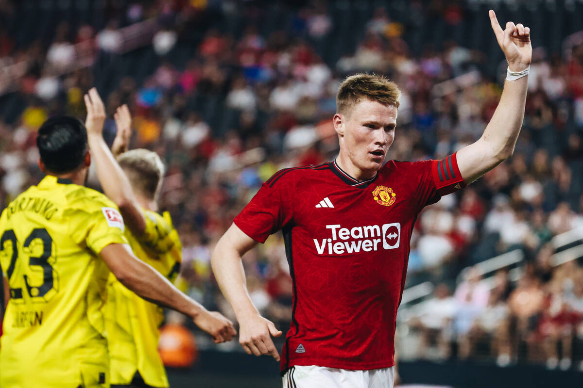 Manchester United midfielder Scott McTominay raises his hand after the referee blew their whis ...