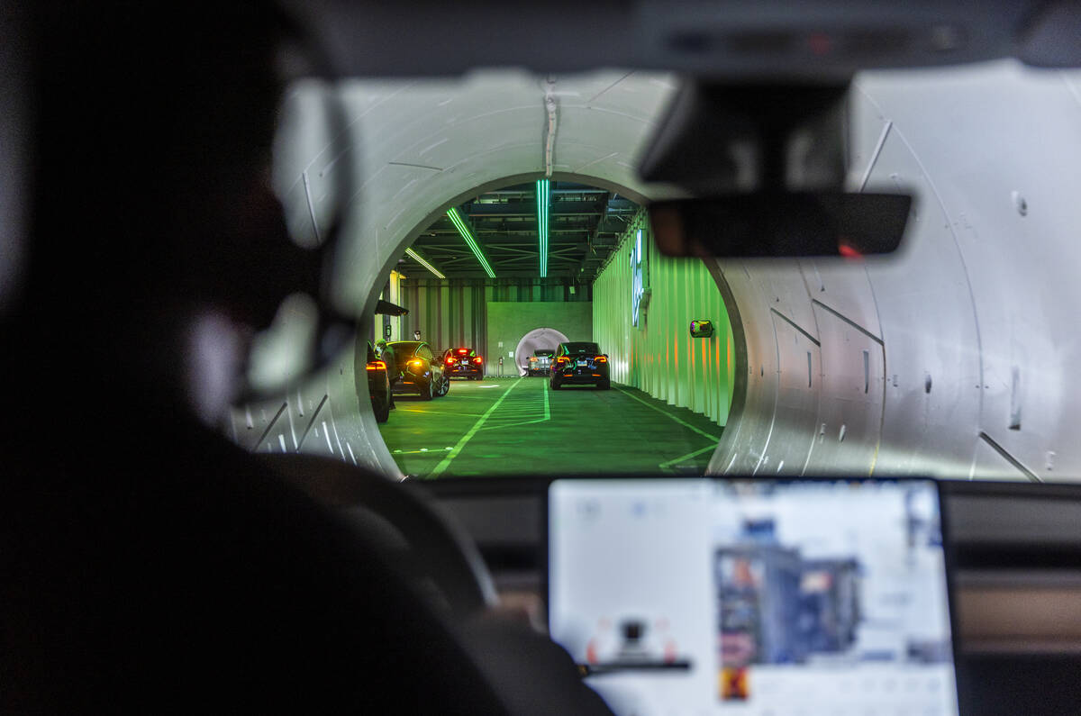 Teslas pick up passengers outside the West Hall station and head underground on the Boring Comp ...