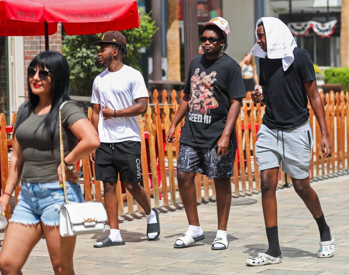 People try to keep cool along the Strip on Monday, July 31, 2023, in Las Vegas. (Daniel Pearson ...