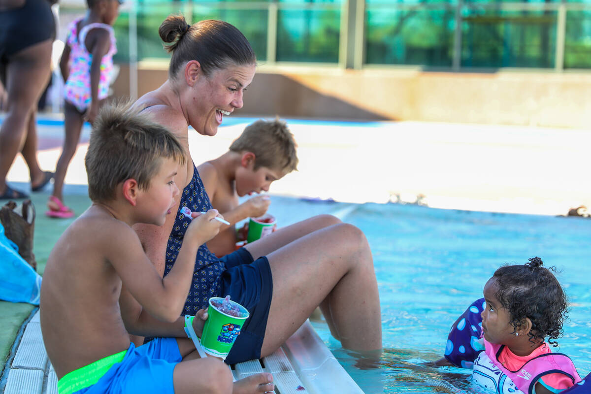 Cynthia Burr, Josie Burr, 2, Aaron Burr, left, and Liam Burr enjoy some shaved ice at the pool ...
