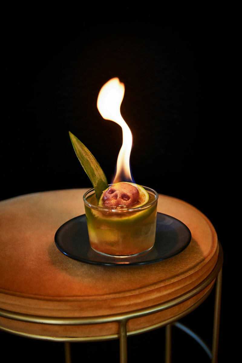 A flaming sugar skull garnish completes the Yucatán Toucan cocktail at La Popular CDMX in the ...