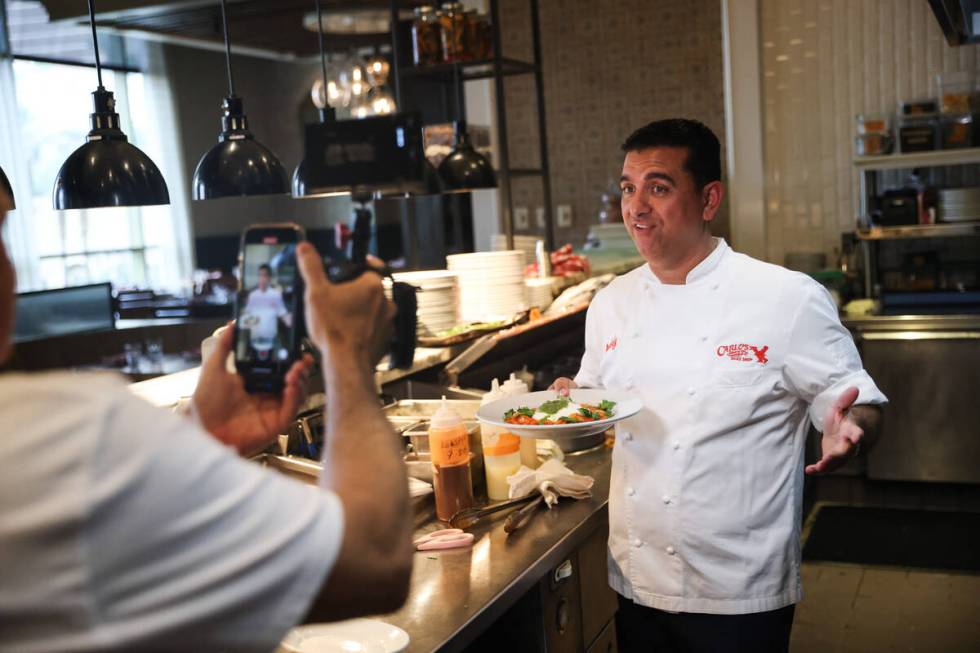 Buddy Valastro, of "Cake Boss" TV show fame, shows off a pasta dish for social media at his res ...