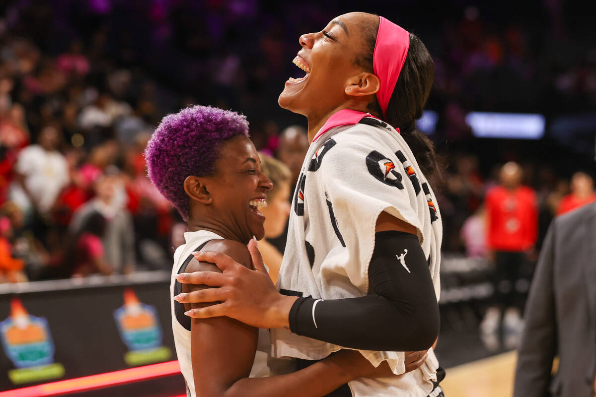 Las Vegas Aces forward A'ja Wilson (22) and Atlanta Dream guard Danielle Robinson (3) share a l ...