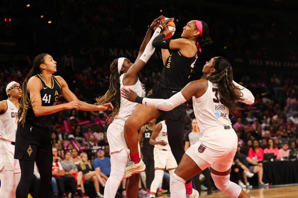 Las Vegas Aces forward A'ja Wilson (22) is fouled by Atlanta Dream guard Rhyne Howard (10) duri ...