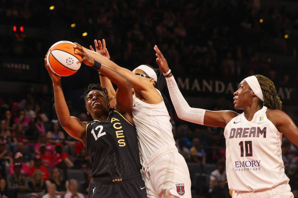 Las Vegas Aces guard Chelsea Gray (12) maneuvers in for a layup during a WNBA basketball game a ...