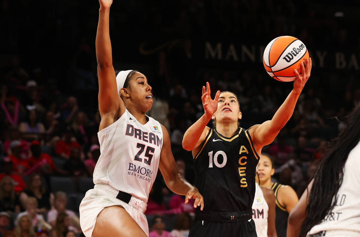 Las Vegas Aces guard Kelsey Plum (10) goes in for a layup around Atlanta Dream forward Monique ...