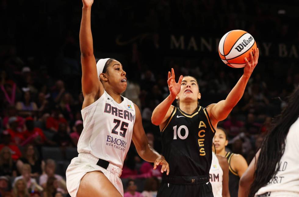 Las Vegas Aces guard Kelsey Plum (10) goes in for a layup around Atlanta Dream forward Monique ...