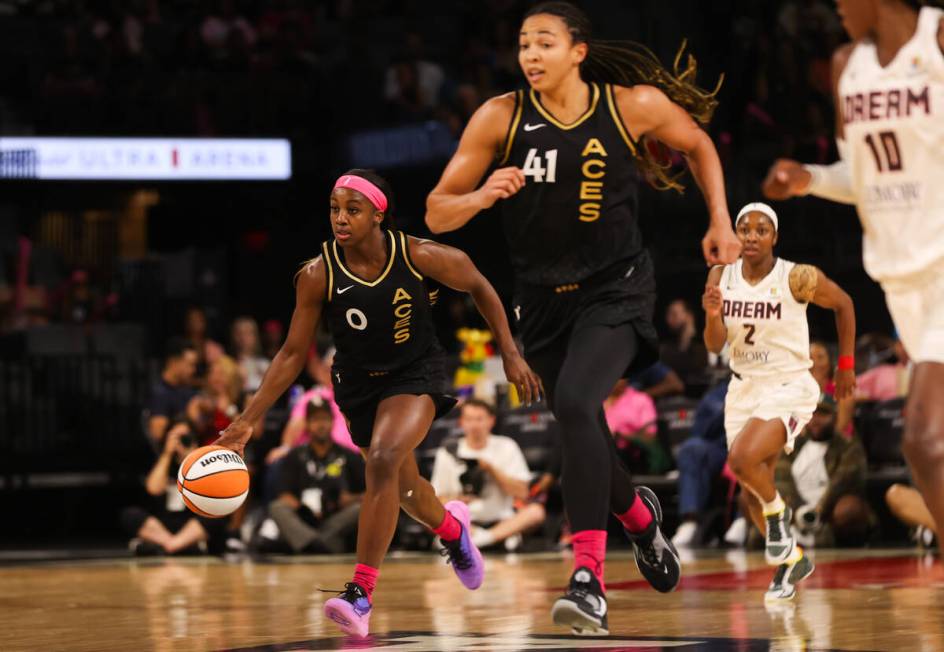 Las Vegas Aces guard Jackie Young (0) dribbles the ball down the court alongside Las Vegas Aces ...