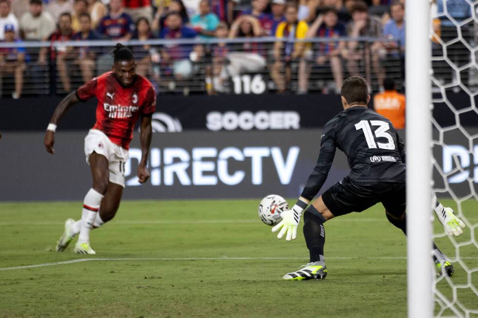 Barcelona goalkeeper Iñaki Peña (13) prepares to save a shot by Milan forward Rafael Leão (1 ...