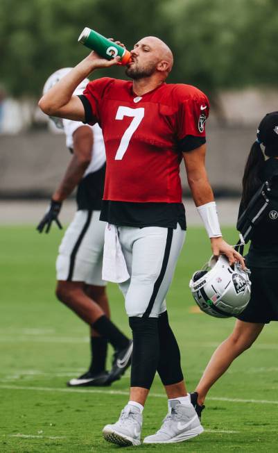 Raiders quarterback Brian Hoyer drinks water during training camp at the Intermountain Health P ...