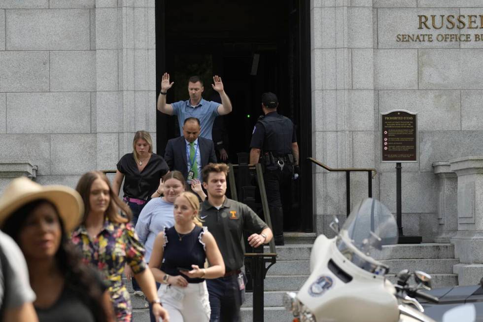 Government staffers walk out of the Russell Senate Office Building on Wednesday, Aug. 2, 2023, ...