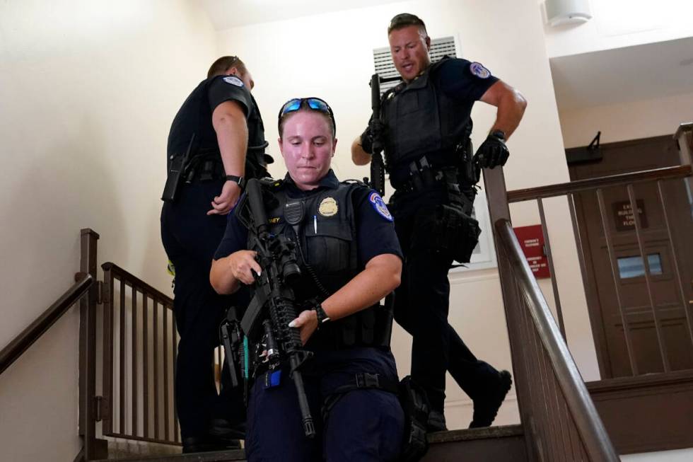 U.S. Capitol Police officers clear a stairwell in the Dirksen Senate Office Building next to th ...