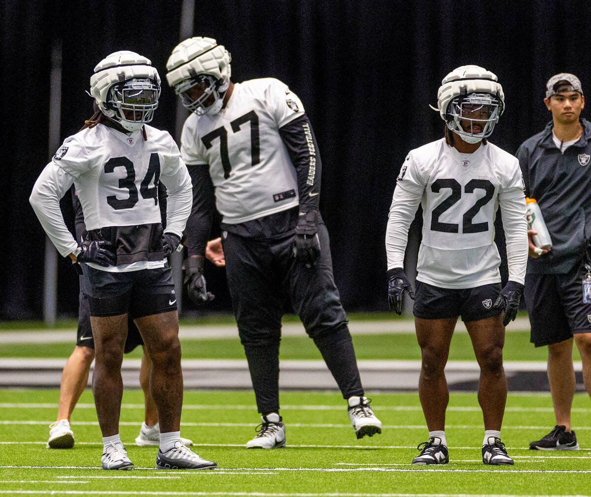 Raiders running back Brandon Bolden (34) stands near offensive tackle Thayer Munford Jr. (77) a ...