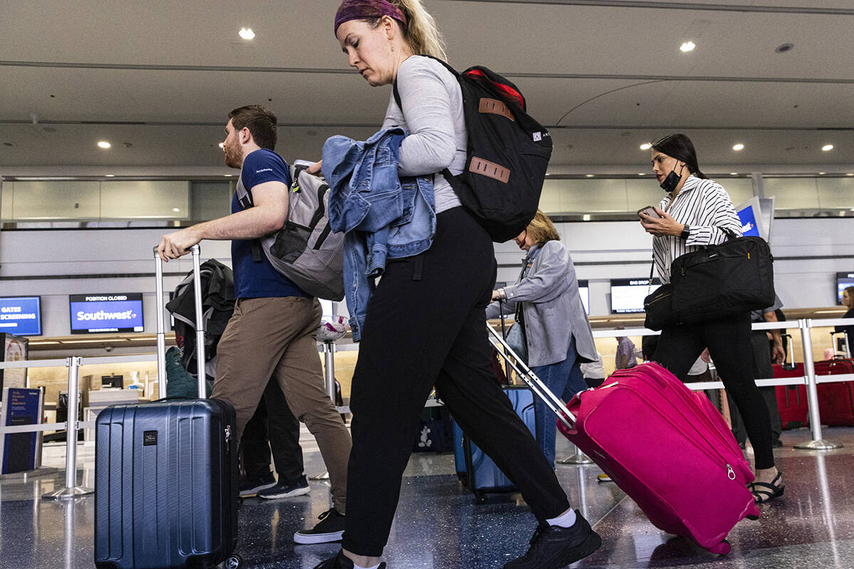 Passengers prepare to check in at Southwest check in counter in Terminal 1 of Harry Reid Intern ...