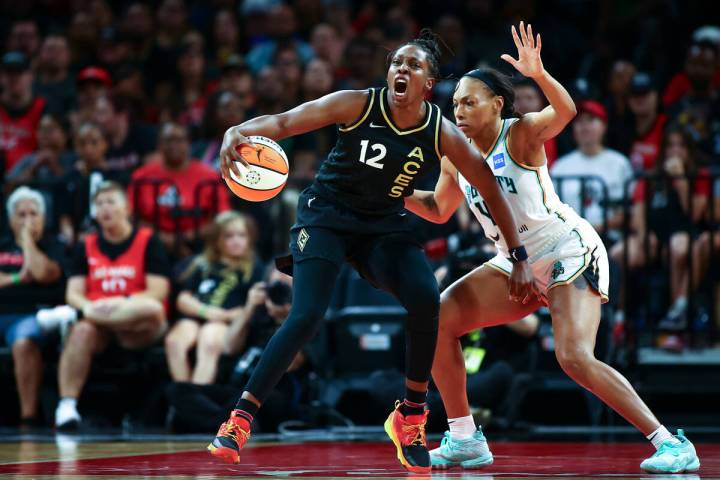 Las Vegas Aces guard Chelsea Gray (12) shouts while dribbling against New York Liberty forward ...