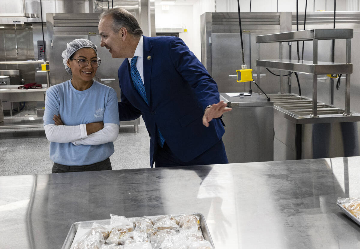 CCSD Superintendent Dr. Jesus F. Jara chats with Claudia Alains, a food worker, as Brandon Baca ...