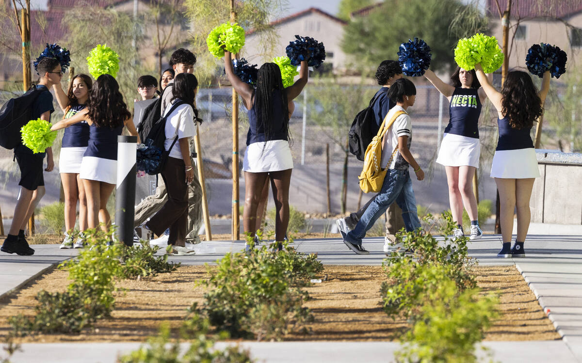 Student at Northeast Career and Technical Academy are greeted by cheerleaders as they arrive to ...