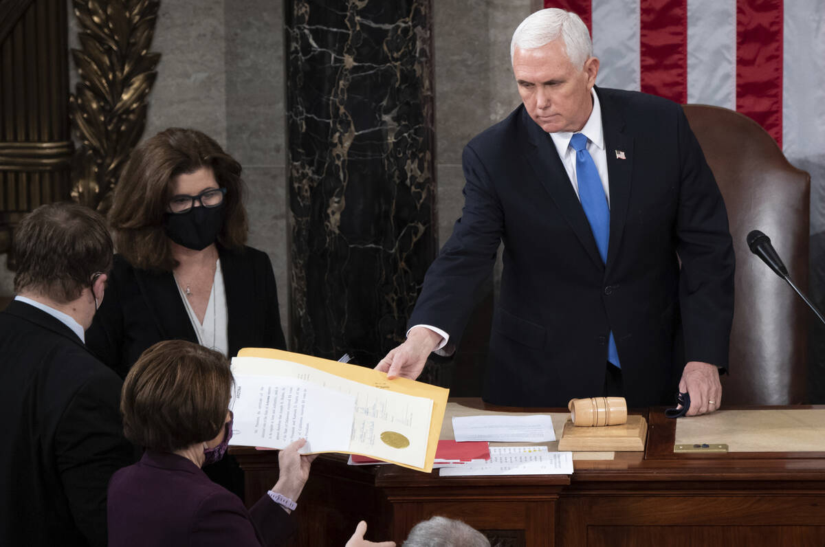 FILE - Vice President Mike Pence hands the electoral certificate from the state of Arizona to S ...