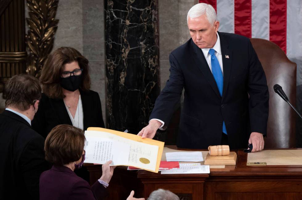 FILE - Vice President Mike Pence hands the electoral certificate from the state of Arizona to S ...