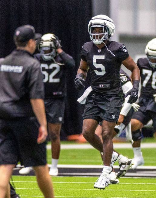 Raiders linebacker Divine Deablo (5) jumps as part of warm ups during training camp at the Inte ...