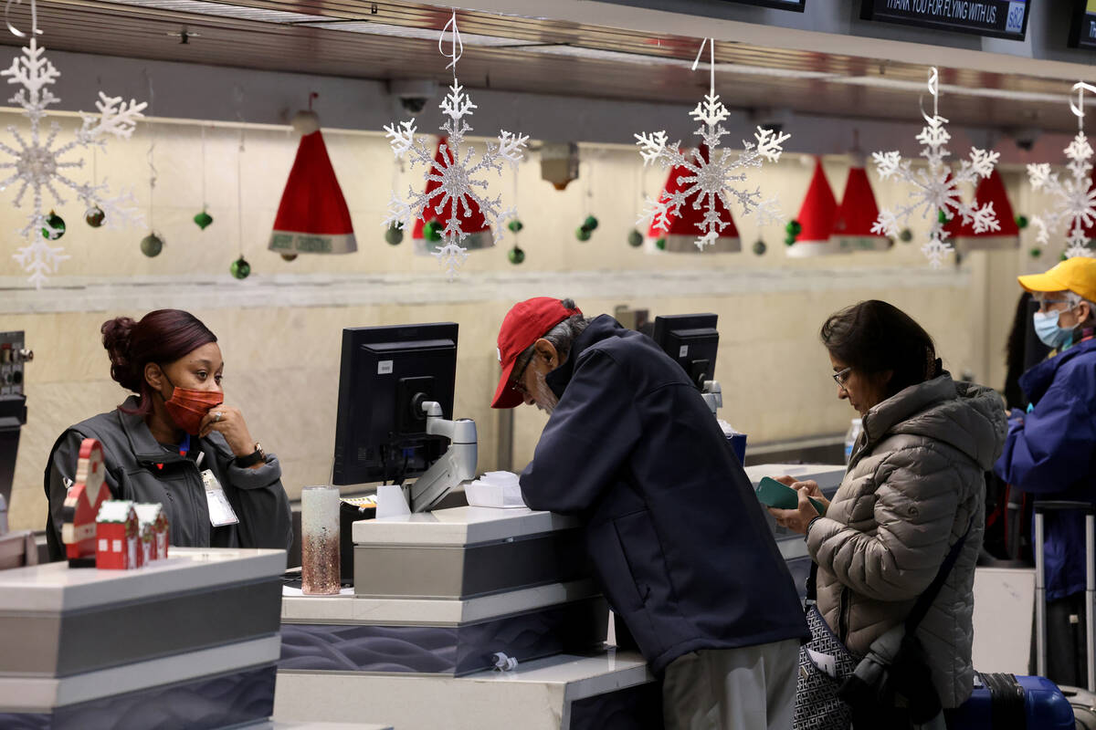 Agents help passengers at the Southwest ticket counter in Terminal 1 at Harry Reid Internationa ...