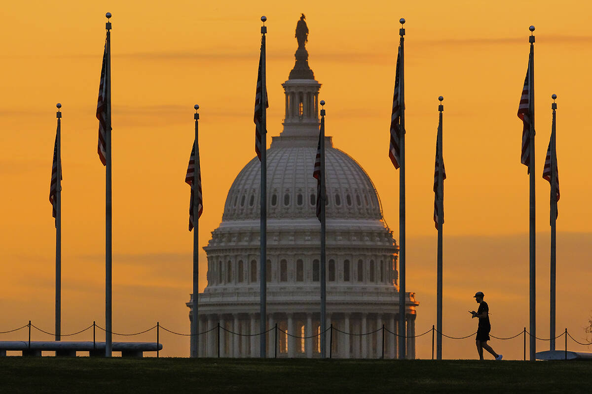 The U.S. Capitol Building looms behind flags on the National Mall in Washington Nov. 7, 2022. ( ...