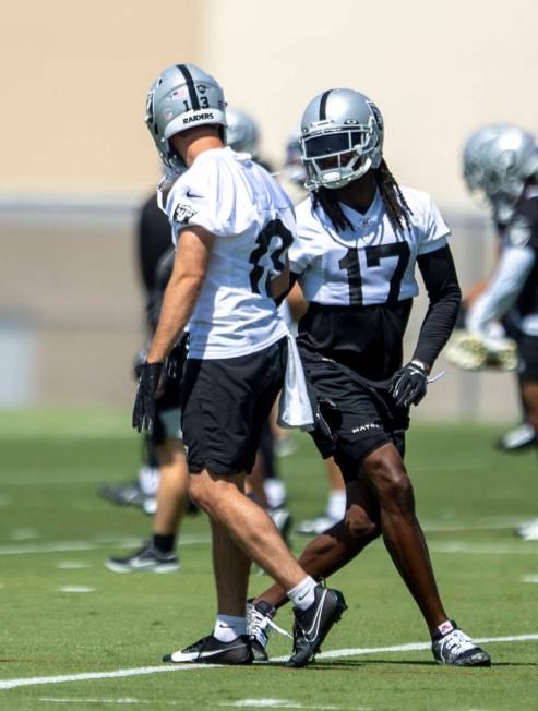 Raiders wide receivers Davante Adams (17) and Hunter Renfrow (13) work closely during their man ...