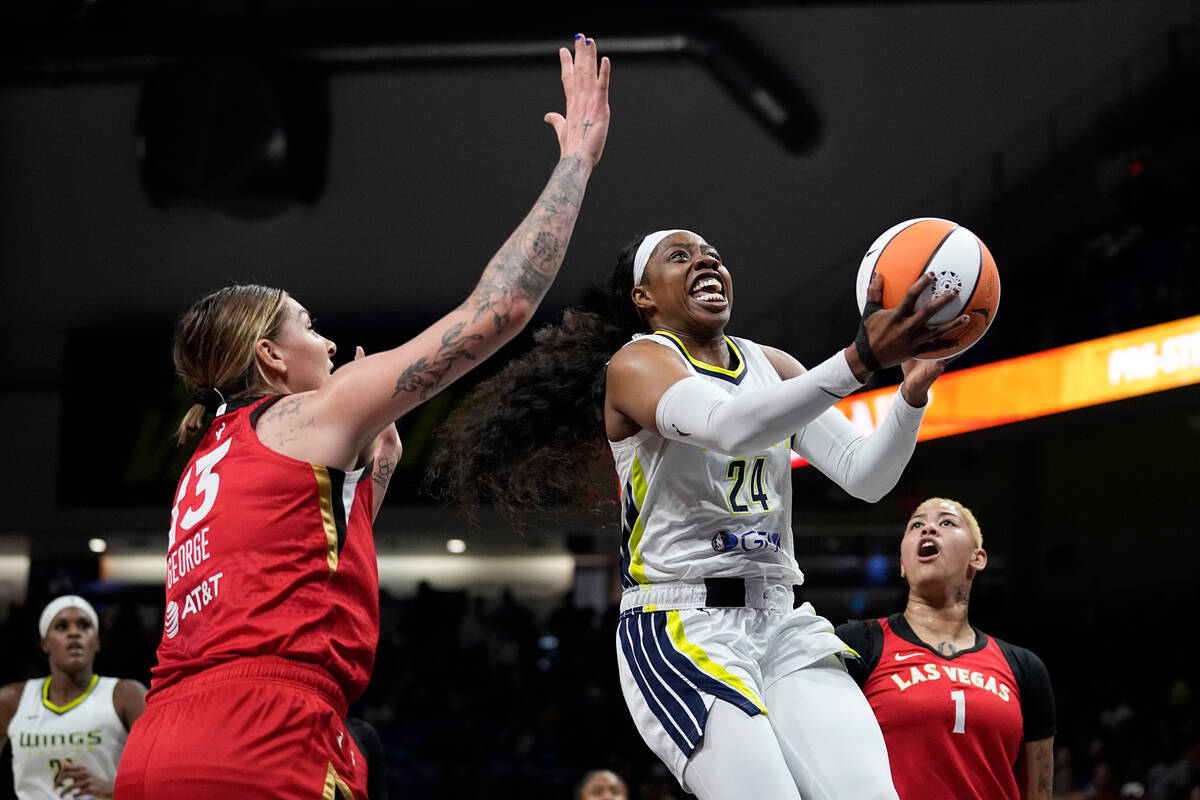 Dallas Wings guard Arike Ogunbowale (24) gets through Las Vegas Aces' Cayla George (13) and Kie ...