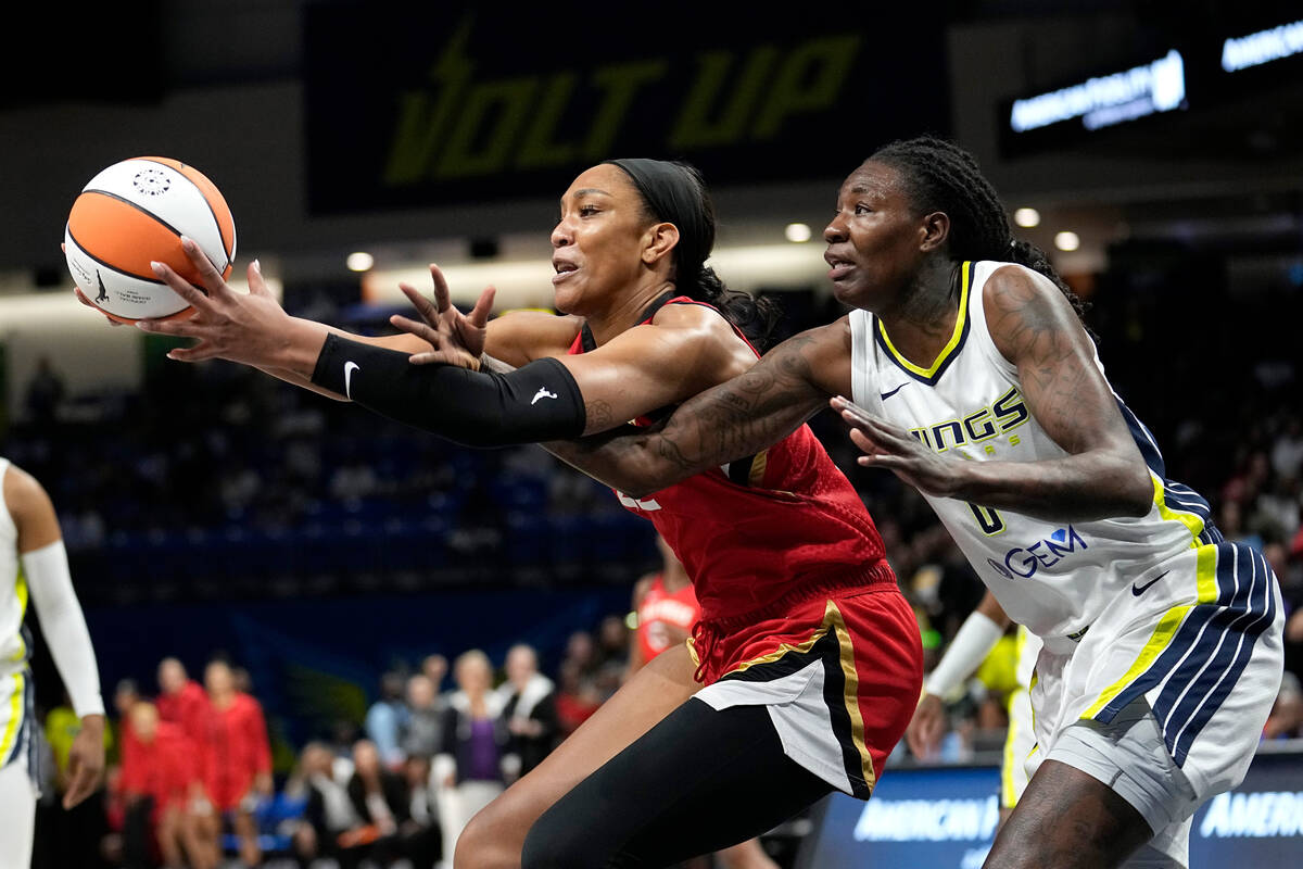 Las Vegas Aces forward A'ja Wilson, left, and Dallas Wings forward Natasha Howard, right, compe ...