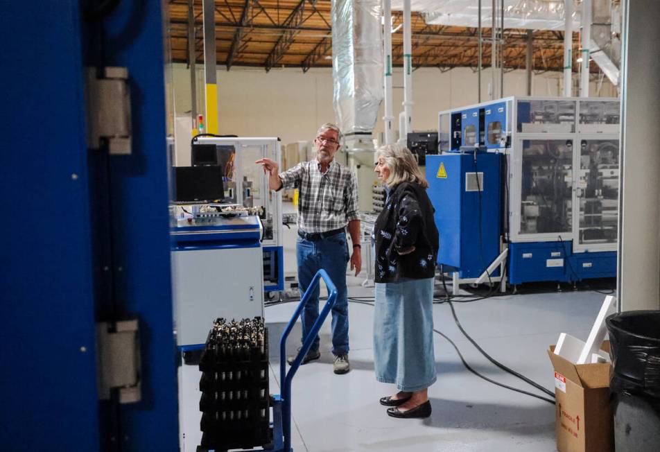 Dr. James Hodge, vice president of power sources, left, leads Rep. Dina Titus, D-Nev., right, o ...