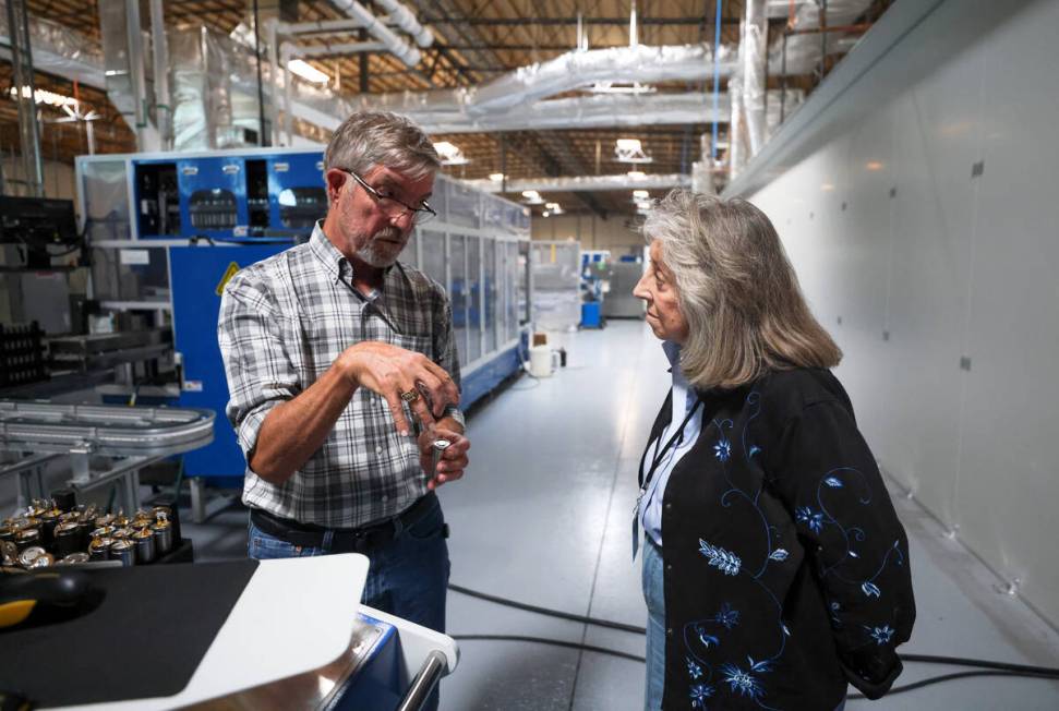 Dr. James Hodge, vice president of power sources, left, leads Rep. Dina Titus, D-Nev., right, o ...