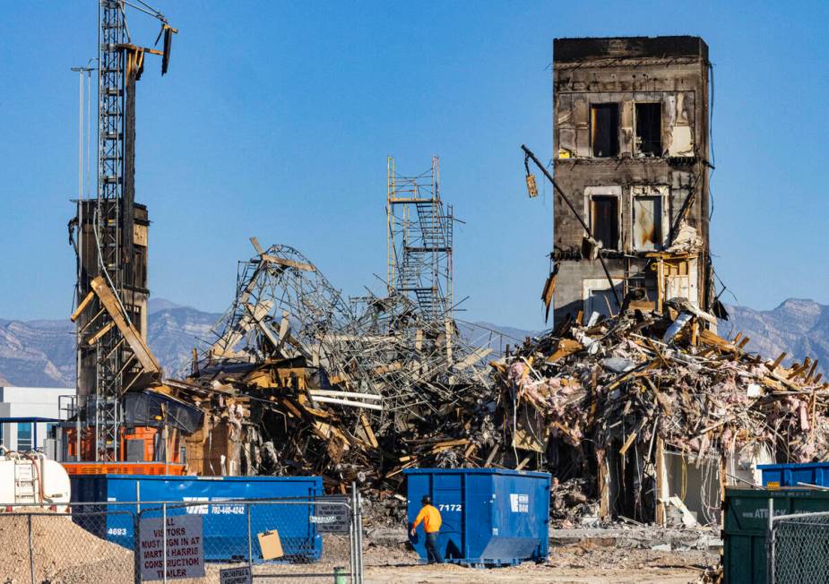 Large piles of debris at the scene where a fire destroyed an apartment complex under constructi ...