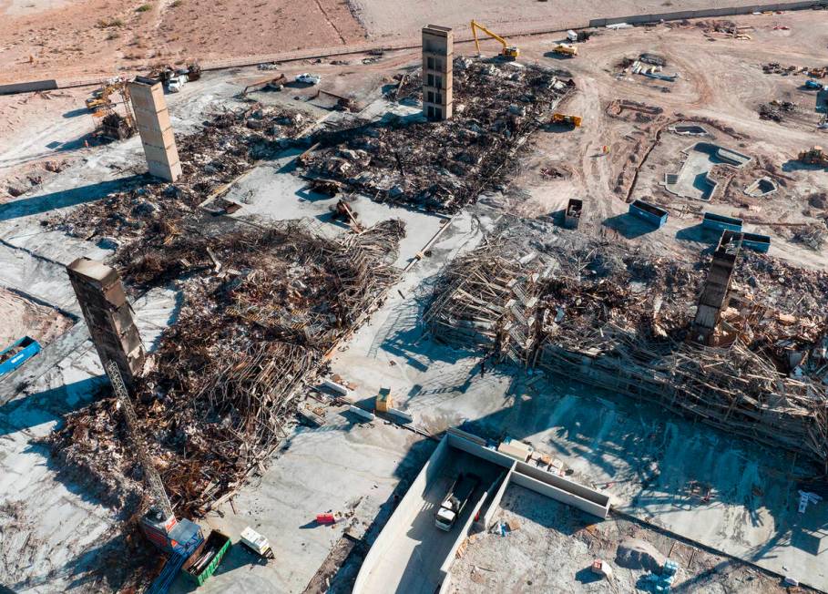 An aerial view shows large piles of debris at the scene where a fire destroyed an apartment com ...