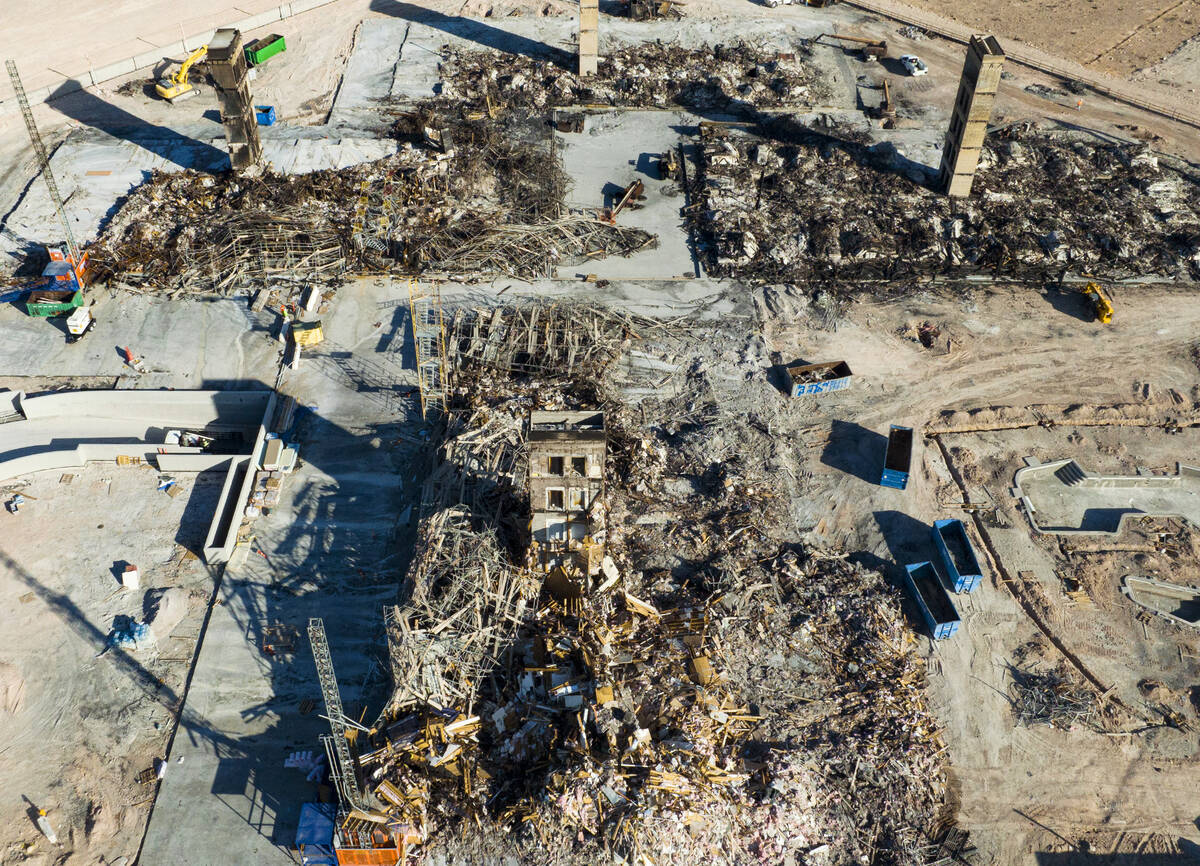 An aerial view shows large piles of debris at the scene where a fire destroyed an apartment com ...