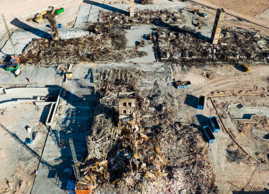 An aerial view shows large piles of debris at the scene where a fire destroyed an apartment com ...